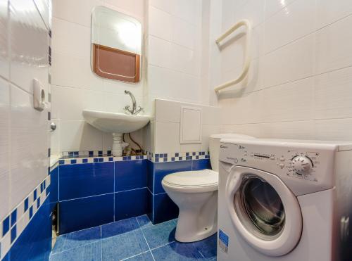 基辅左岸日间公寓的浴室配有卫生间、盥洗盆和洗衣机。