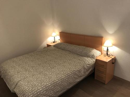 布拉内斯La mestrança的一间卧室配有一张床和两张台灯。