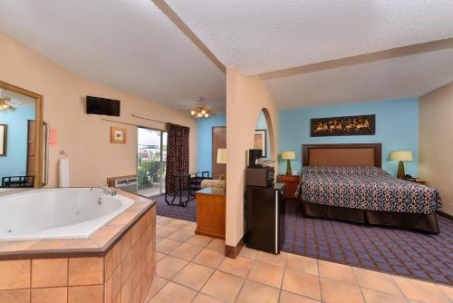 阿德莫尔阿德莫尔经济旅馆的一间卧室配有一张床和浴缸