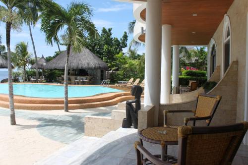 邦劳丽娜海滩度假村的一个带游泳池和棕榈树的度假村