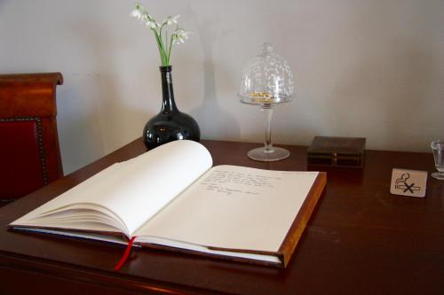 Heenvliet特库塔什度假屋的一张桌子上的开本书,花瓶