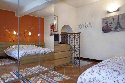 奥尔塔圣朱利奥卡梅拉多切诺特旅馆的一间卧室配有两张床和镜子