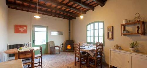 RellinarsMasia CasaJoana Rural的一间带桌椅和壁炉的用餐室