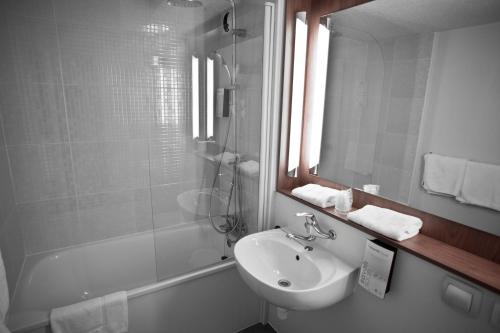 保拉扎克Ampaline HOTEL - Perigueux Boulazac的一间带水槽、镜子和淋浴的浴室