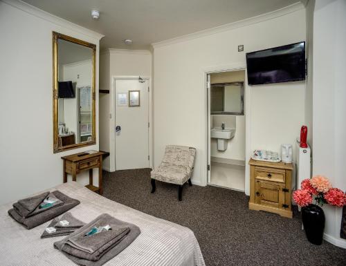 诺里奇Riverside Hotel的客房设有两张床、一个水槽和镜子