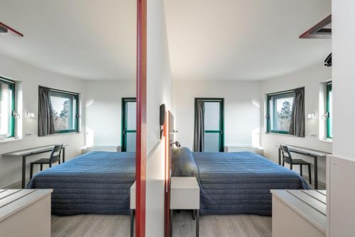 维罗纳派力奥门酒店的一间卧室配有两张床和一张桌椅