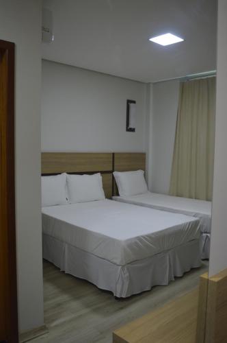 里约布兰科Villa Rio Branco Hotel Concept的白色墙壁客房的两张床