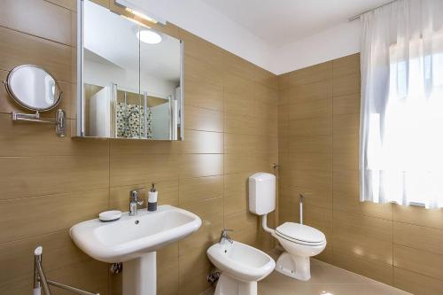 普拉Apartment VIVIANA的一间带水槽、卫生间和镜子的浴室