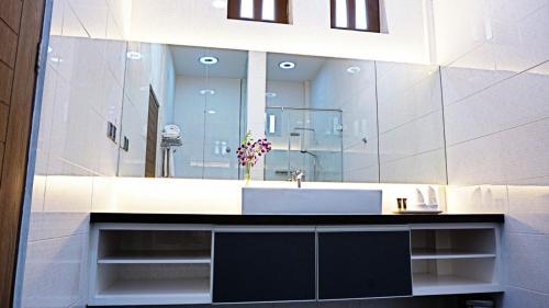 邦咯Casuarina Pangkor的一间带水槽和大镜子的浴室