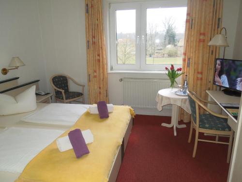 巴特法灵博斯特尔施海根酒店的酒店客房,配有两张带紫色弓的床