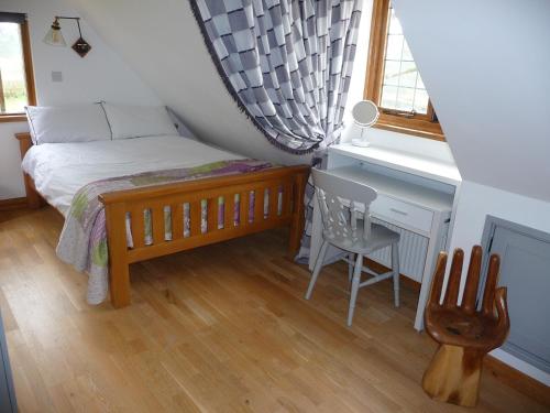TerlingOakwrights的一间卧室配有一张床、一张桌子和一把椅子