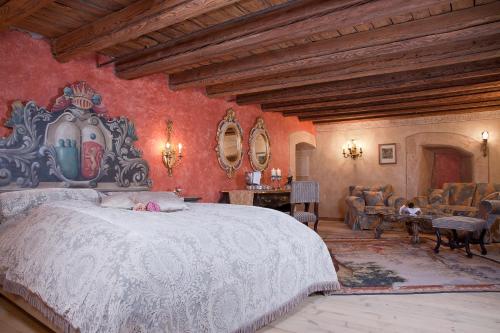 阿尔普巴赫谷地赖特Schloss Matzen的卧室设有白色大床和红色墙壁