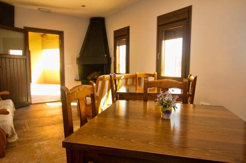 La Almunia de San JuanCasa Codeta的用餐室配有带鲜花的木桌
