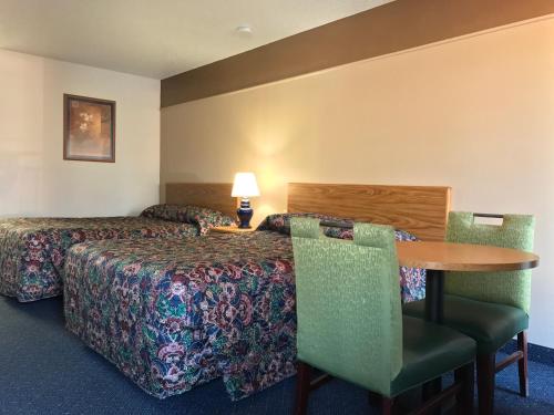 堪萨斯城堪萨斯城美国酒店，KS的酒店客房带一张床、一张桌子和椅子