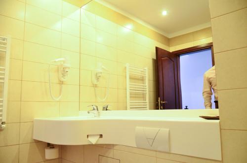 拉姆尼库沃尔恰米拉吉酒店的一间带水槽和镜子的浴室