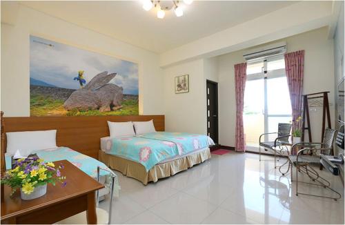 台东台东的家民宿的一间卧室配有一张床、一张桌子和一张桌子