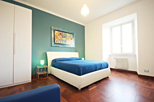 罗马Rome Aparts的一间卧室配有一张带蓝色毯子的床