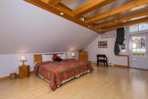 拜圣保罗Aux petits oiseaux CITQO96751的一间卧室设有一张大床,铺有木地板