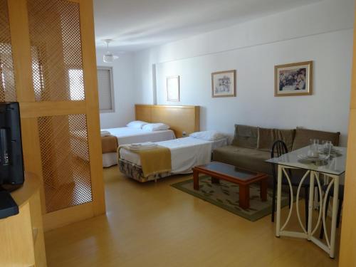 圣保罗日内瓦公寓式酒店的一间带两张床和一张沙发的客厅