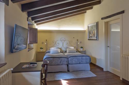 圣保Hotel Cal Sastre的卧室配有一张床和一张桌子