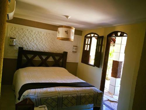 卡博迪圣阿戈斯蒂尼奥Pousada Acgua Residenz的一间卧室设有一张床和一个窗口