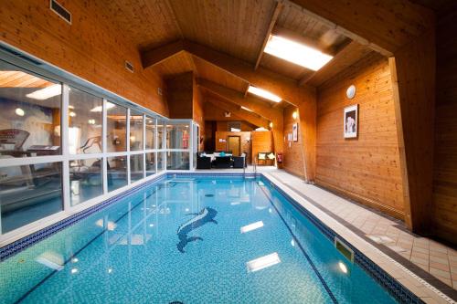 彼索普斯托福猎人相约酒店的大型建筑内的大型游泳池,设有游泳池