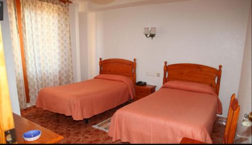 Hotel Los Arcos客房内的一张或多张床位