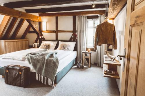 Birkenau兰莫硕夫兰德酒店的一间卧室配有一张床和一个行李箱