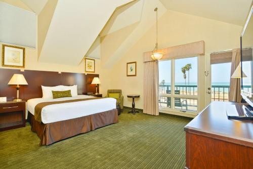 丹纳岬达纳波因特海滨贝斯特韦斯特酒店的酒店客房设有一张床和一个阳台。