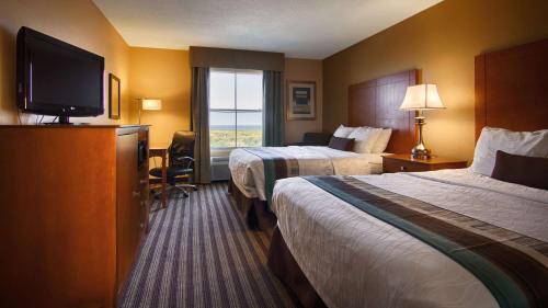 加尔维斯敦贝斯特韦斯特优质海滨海堤酒店及套房的酒店客房设有两张床和一台平面电视。