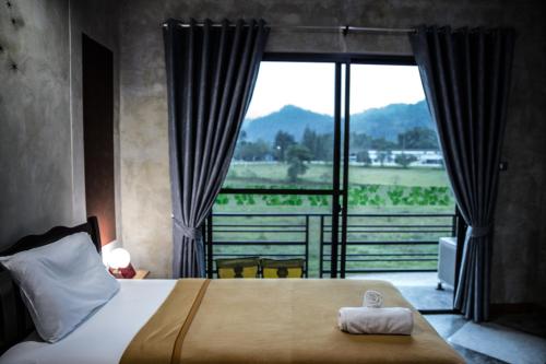 拉廊博特豪斯度假村的一间卧室设有一张床和一个大窗户