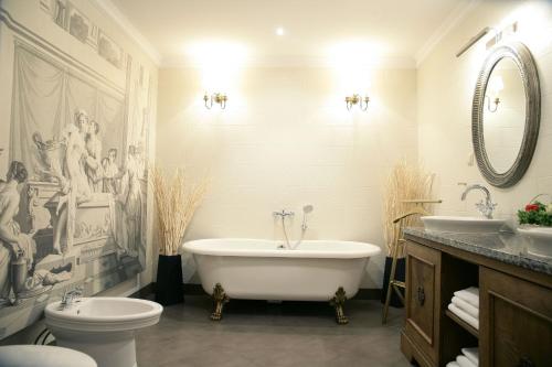 Kaliszki花椰菜庄园酒店的带浴缸、卫生间和盥洗盆的浴室