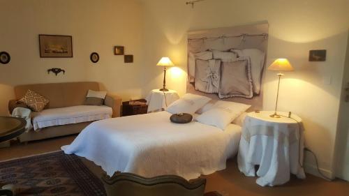 Saint-Branchs德帕奇莱旅馆的卧室配有一张白色的大床和一张沙发。