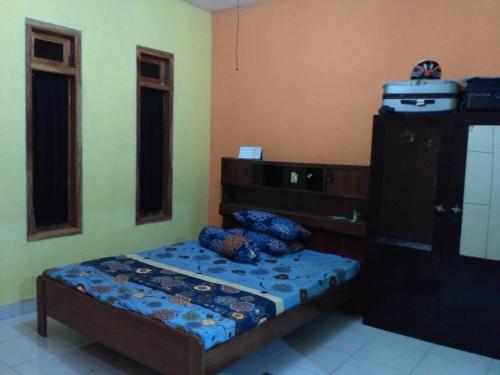 普兰巴南mas Eko Jlatren kost homestay的一间小卧室,配有一张床和一个梳妆台
