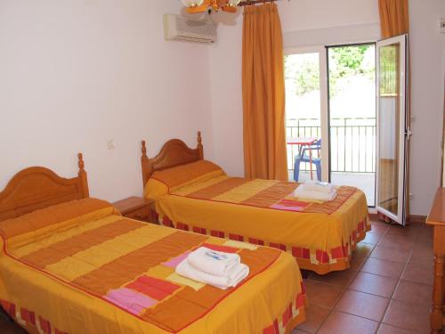 科托里奥斯皮纳尔乡村公寓的酒店客房设有两张床和一个阳台。