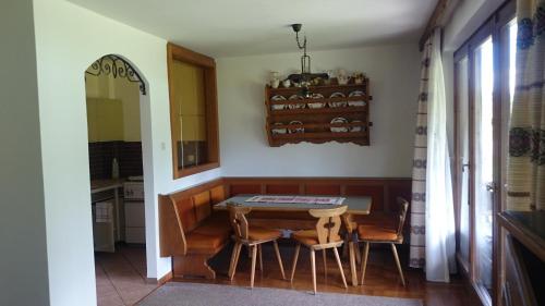 韦尔特湖畔克伦彭多夫Seebungalows Wedenig direkt am See的一间带桌子和两把椅子的用餐室
