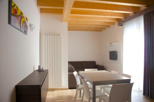 卡奥莱Residence la Perla的厨房以及带桌椅的用餐室。