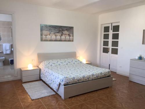 PontesturaAppartamento Il Nido的一间卧室配有一张床,浴室设有两盏灯。