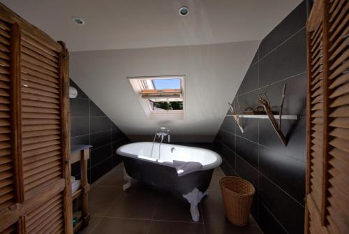 利翁拉福雷大赛尔夫和Spa酒店的浴室配有黑白浴缸和水槽