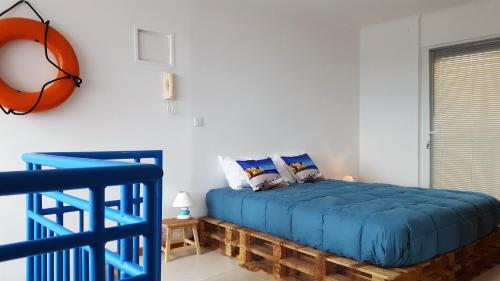 坎普自由鎮Farol da Vila的卧室配有蓝色的床和墙上的篮球