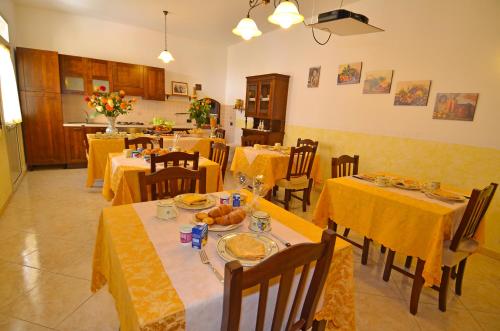 莫尔恰诺迪莱乌卡Le Fate del Salento的用餐室配有桌椅和黄色桌布
