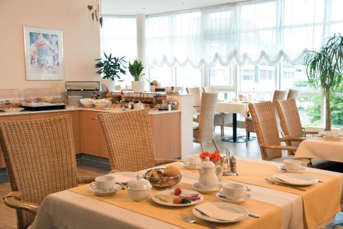 腓特烈斯多夫阿卡迪亚酒店的一间带桌椅的用餐室和一间厨房