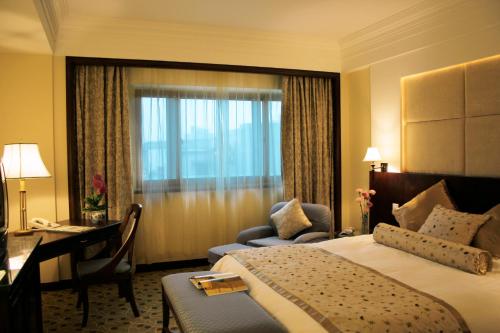 北京北京国宾酒店的酒店客房配有一张床、一张书桌和一张书桌。