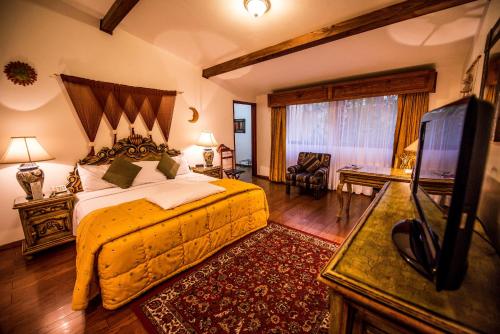 瓜达拉哈拉拉麦森德索酒店的一间卧室配有一张床和一台平面电视