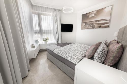 Apartamenty Horyzont Perła客房内的一张或多张床位