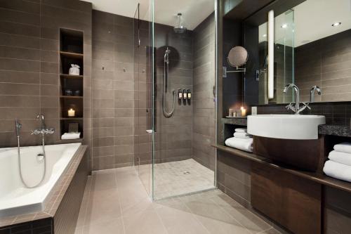 魁北克市Hotel 71 by Preferred Hotels & Resorts的带浴缸、水槽和淋浴的浴室