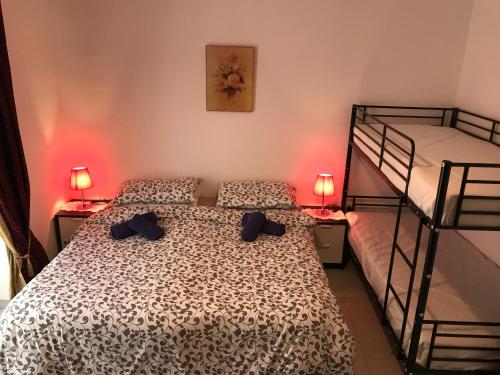 圣朱利安斯Swieqi Semi Detached Maisonette的一间卧室设有两张双层床和两盏灯。