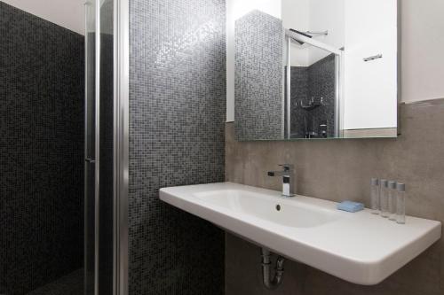 阿尔巴·阿德里亚蒂卡伊甸园酒店的浴室设有白色水槽和镜子