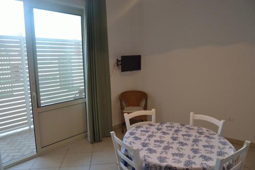 莱乌卡A casa di Elena的一间带桌椅和窗户的用餐室