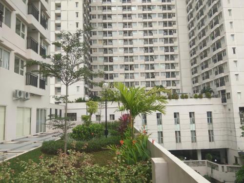 德波DSR Apartment Margonda Residence 5的享有种植植物的大型公寓楼的景色